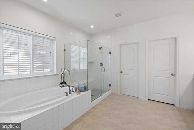 bathroom with separate shower and tub and tile patterned floors