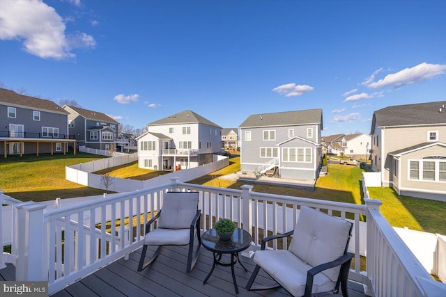 wooden terrace featuring a lawn