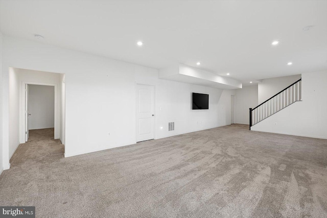 unfurnished living room with light colored carpet