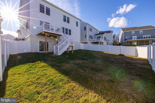 rear view of house featuring a yard and a deck