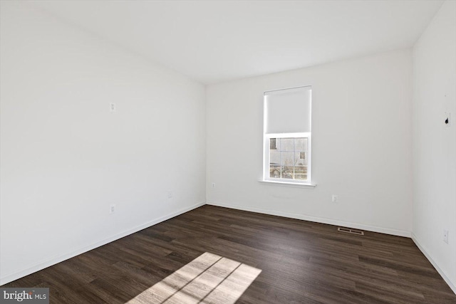 unfurnished room featuring dark hardwood / wood-style floors