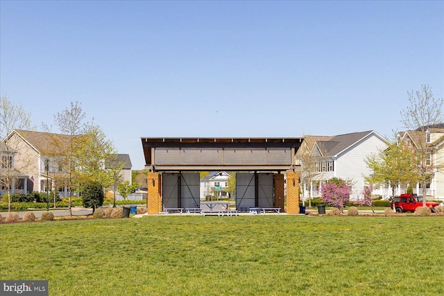 rear view of house with a yard and a carport