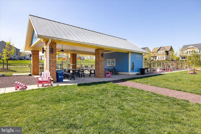 surrounding community with a lawn and a patio