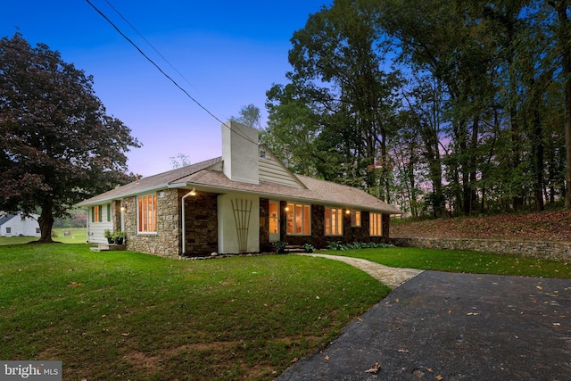 view of front of house with a yard