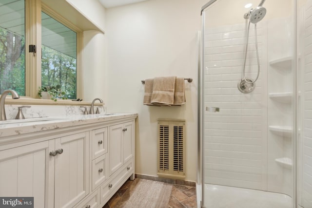 bathroom featuring vanity and a shower with door