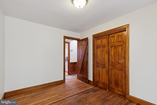 unfurnished bedroom featuring dark hardwood / wood-style flooring