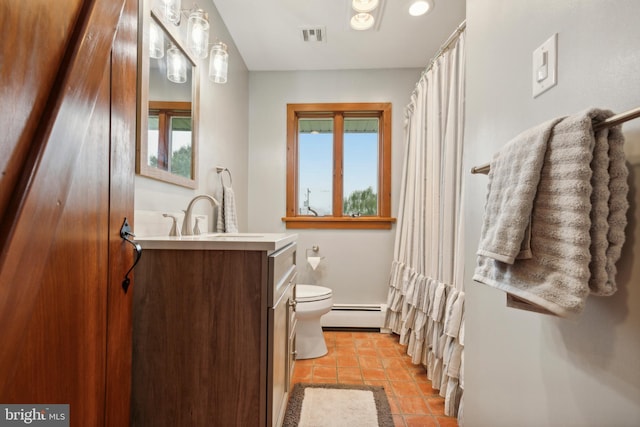 bathroom featuring tile patterned floors, vanity, a baseboard heating unit, and toilet