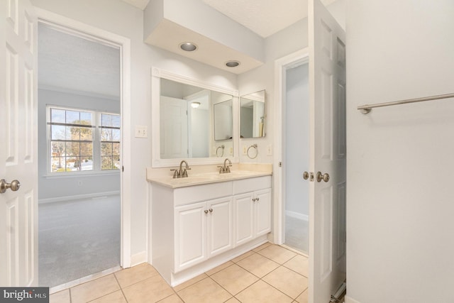 bathroom featuring tile patterned flooring, vanity, and a textured ceiling