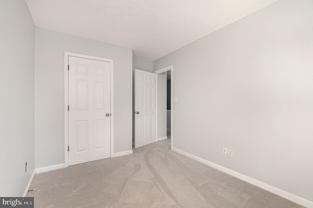 unfurnished bedroom featuring light colored carpet