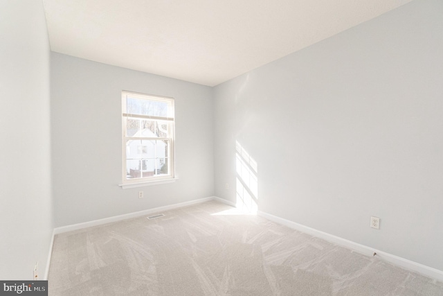 spare room with light colored carpet