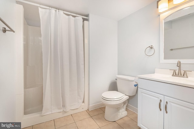 bathroom featuring tile patterned floors, vanity, toilet, and walk in shower