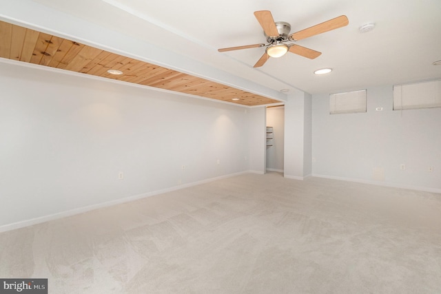 carpeted spare room with ceiling fan and wooden ceiling