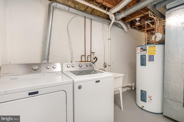 clothes washing area featuring independent washer and dryer and water heater