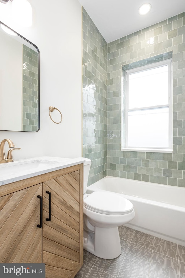 full bathroom with vanity, toilet, and  shower combination