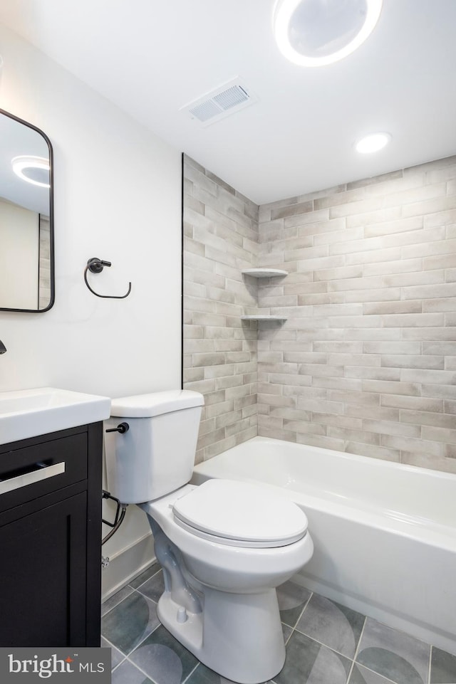 full bathroom featuring vanity, toilet, and tiled shower / bath