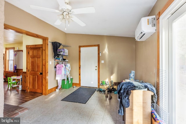 interior space featuring an AC wall unit and ceiling fan