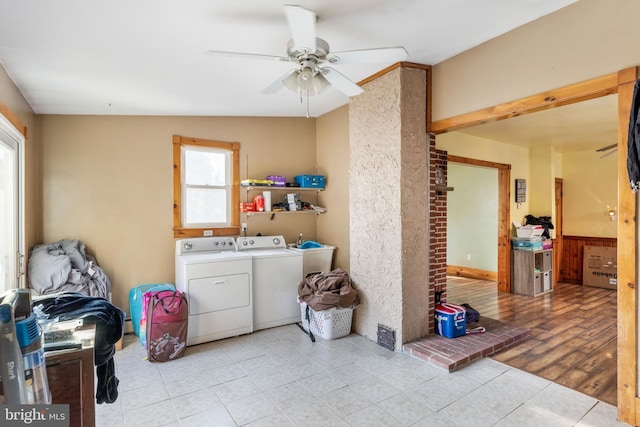 clothes washing area featuring ceiling fan, separate washer and dryer, and light tile patterned floors