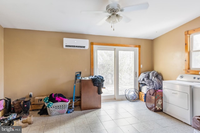 laundry room with independent washer and dryer, a wall unit AC, ceiling fan, and a healthy amount of sunlight