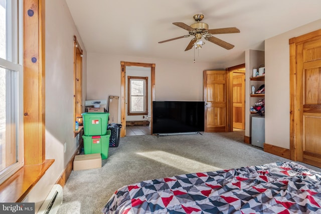 bedroom featuring ceiling fan, carpet floors, and a baseboard heating unit