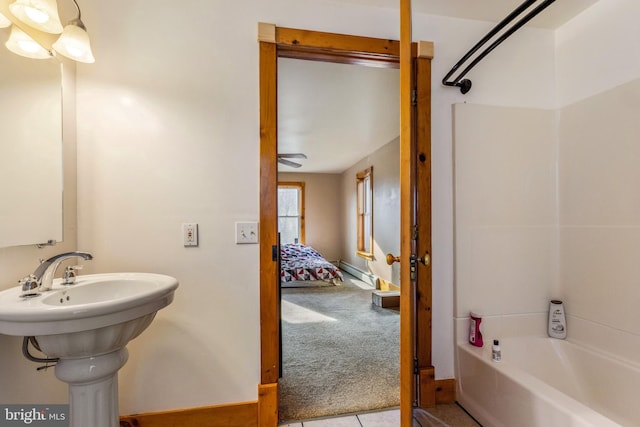 bathroom featuring a baseboard radiator, shower / washtub combination, and sink