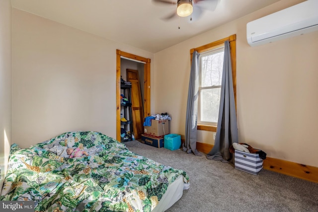 bedroom with carpet flooring, a wall mounted AC, and ceiling fan