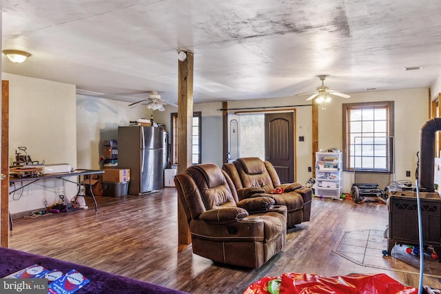 living room with ceiling fan and dark wood-type flooring