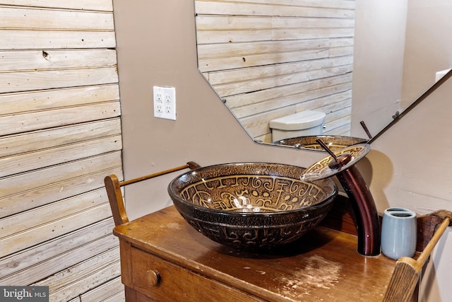 room details featuring wooden walls and sink