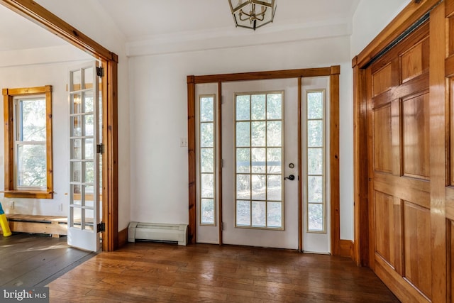 doorway to outside featuring plenty of natural light, dark hardwood / wood-style flooring, baseboard heating, and vaulted ceiling