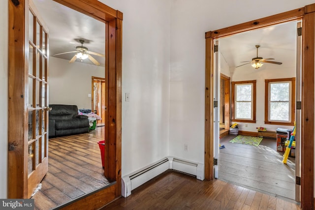 hall with baseboard heating and dark wood-type flooring