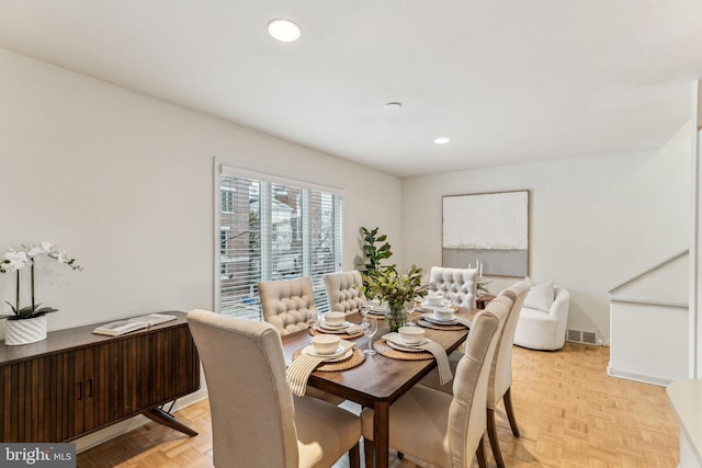 dining space with light parquet floors