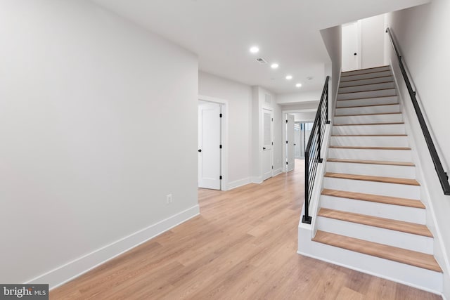 staircase featuring hardwood / wood-style floors