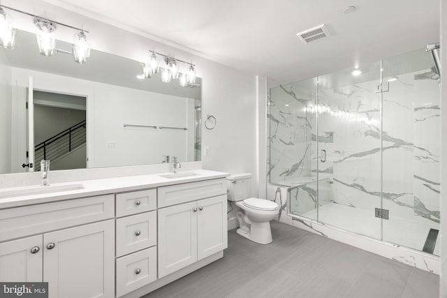 bathroom with an enclosed shower, vanity, and toilet