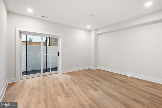 spare room with light hardwood / wood-style flooring