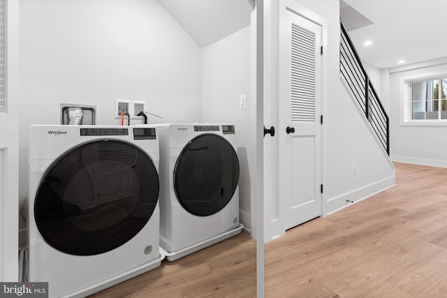 laundry room featuring light wood-type flooring and independent washer and dryer