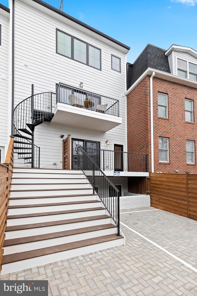 rear view of house featuring a balcony