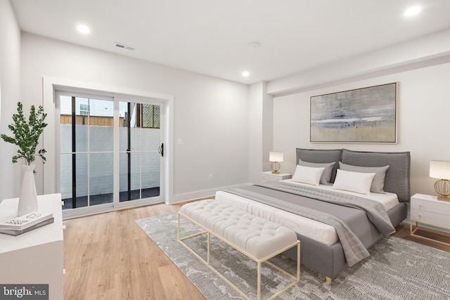 bedroom featuring access to outside and light hardwood / wood-style floors