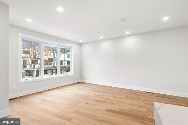 unfurnished room with light hardwood / wood-style floors