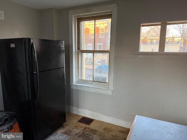 kitchen featuring black fridge