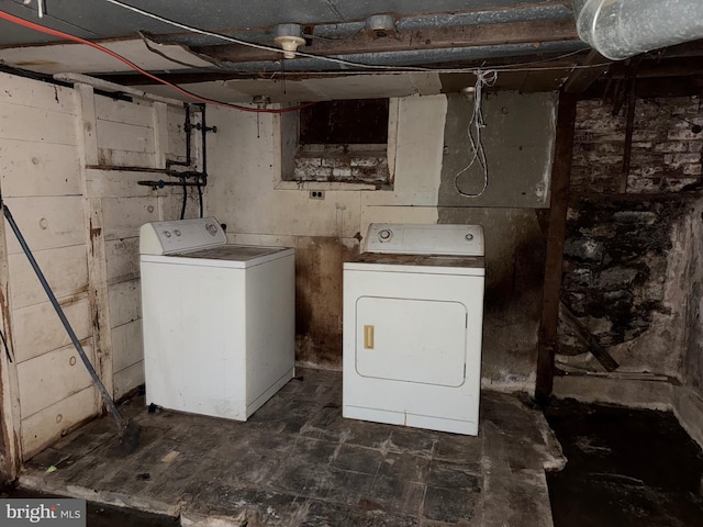 clothes washing area with washing machine and clothes dryer