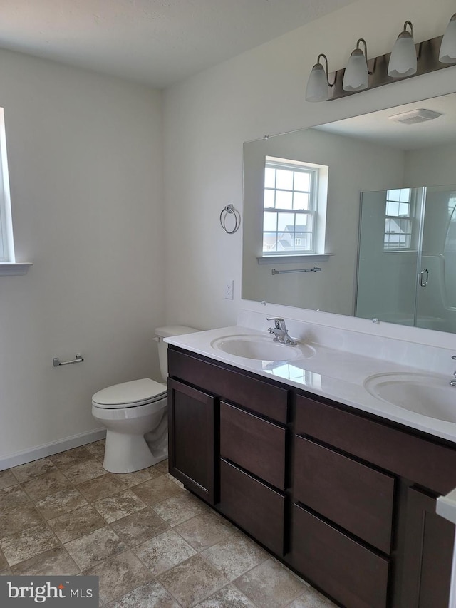 bathroom with vanity, toilet, and walk in shower