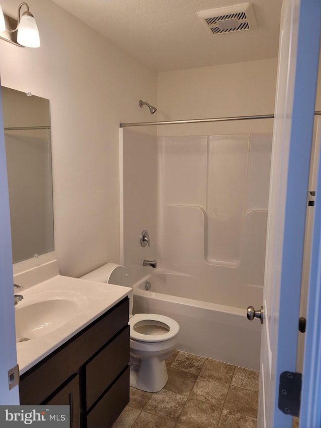 full bathroom with vanity, tub / shower combination, and toilet