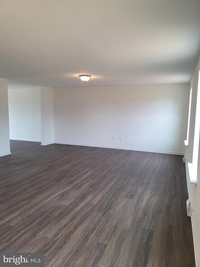 unfurnished room with dark hardwood / wood-style floors