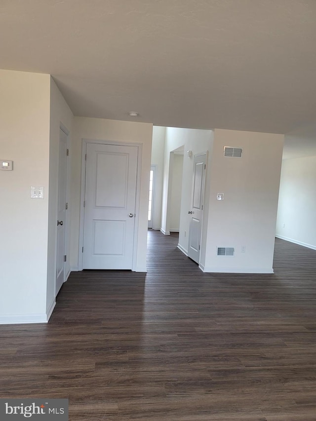 empty room featuring dark wood-type flooring