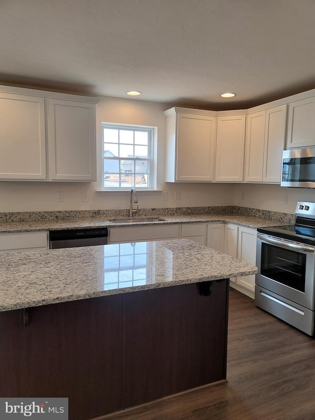 kitchen featuring white cabinets, dark hardwood / wood-style flooring, sink, and appliances with stainless steel finishes