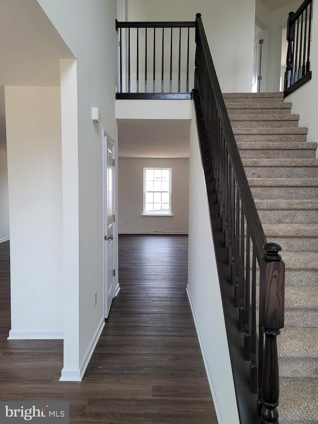 staircase with wood-type flooring