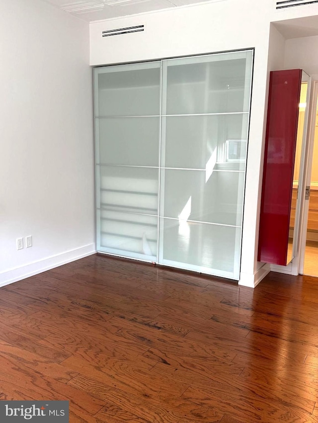 empty room featuring dark hardwood / wood-style flooring