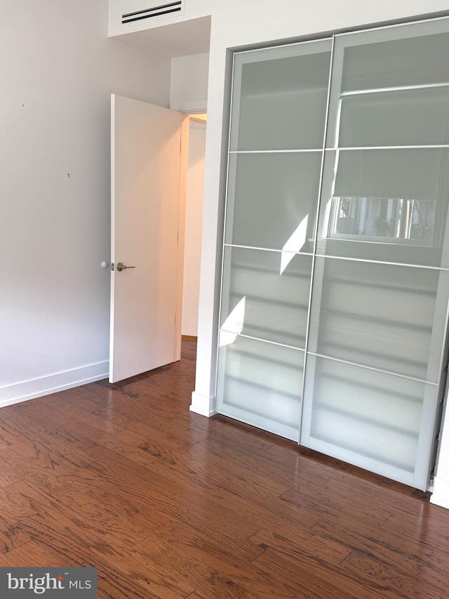 empty room featuring dark wood-type flooring