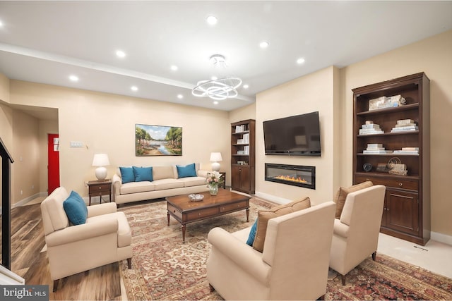 living room featuring built in features and a notable chandelier