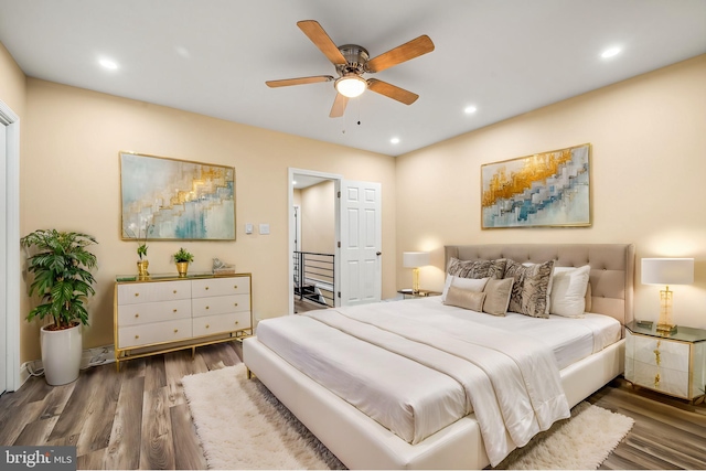 bedroom with ceiling fan and dark hardwood / wood-style flooring