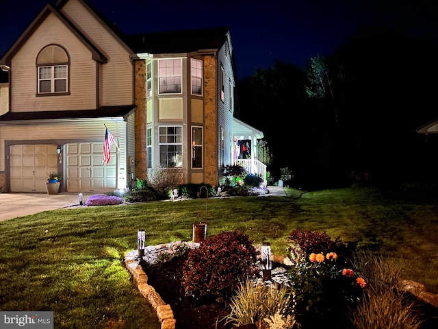 view of front of house featuring a yard and a garage